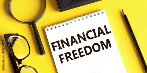 Notebook With the Words Financial Freedom Beside Glasses
