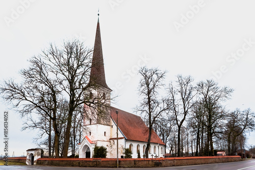 Historic Nurme Lutheran Church building with stone wall in Latvia