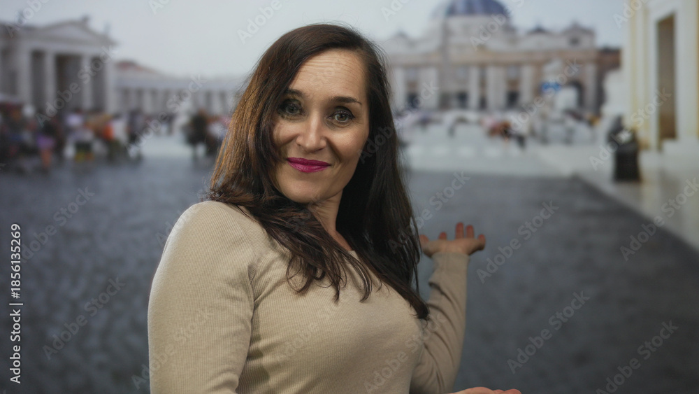 Fototapeta premium Young hispanic woman extends hands backward presenting vatican square; joy invitation discovery admiration.