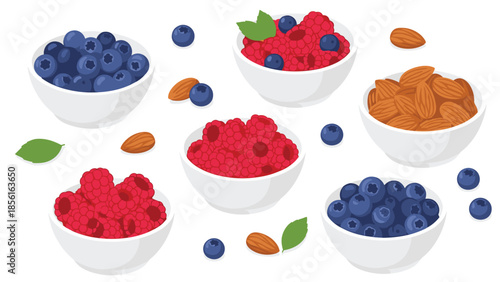 Assortment of fresh blueberries and raspberries in white bowls, accompanied by natural almonds, showcasing healthy and wholesome snacks.