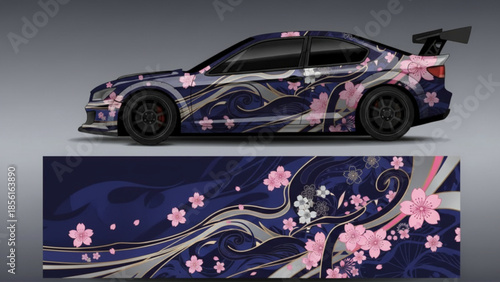 A sports car with a custom dark blue wrap featuring flowing silver patterns and pink cherry blossoms.