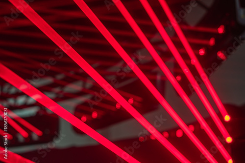 Slika na platnu A dynamic, vibrant laser show with red beams intersecting in an abstract geometr