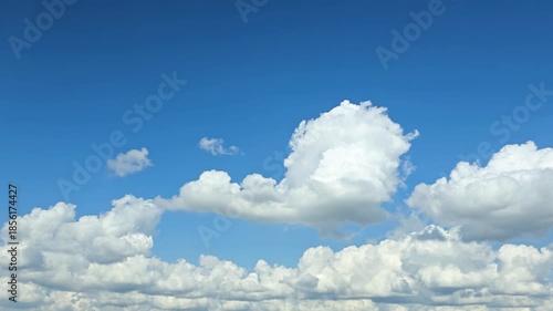 Timelapse, blue Sky clouds background atmosphere with large cumulus formation in summer daylight, bright peaceful serene mood