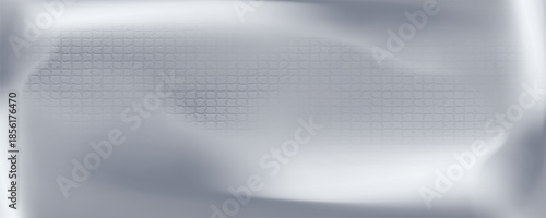 Silver foil background with a metallic mirror texture. Chrome gradient surface with soft, abstract light.