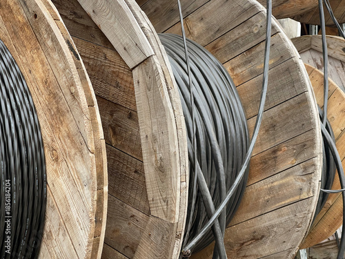 Industrial cable spool wooden reel electrical wire infrastructure for power distribution telecommunications construction site and utility network installation projects