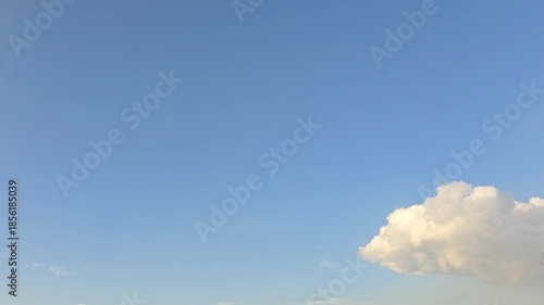 Timelapse, Clear blue sky background with minimal clouds, simple composition, modern and tranquil mood