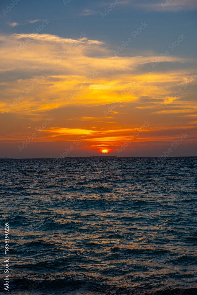 Obraz premium Beautiful sunset. Tranquil closeup calm sea water waves with palm trees. Tropical island beach landscape exotic shore coast. Summer vacation, holiday amazing nature, Maldives.