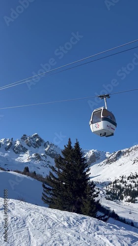 View of ski lifts, white gondolas in Courchevel ski resort, French alps, France by winter during ski season