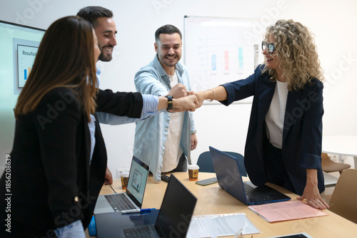 Foto Business team celebrating success with fist bump gesture