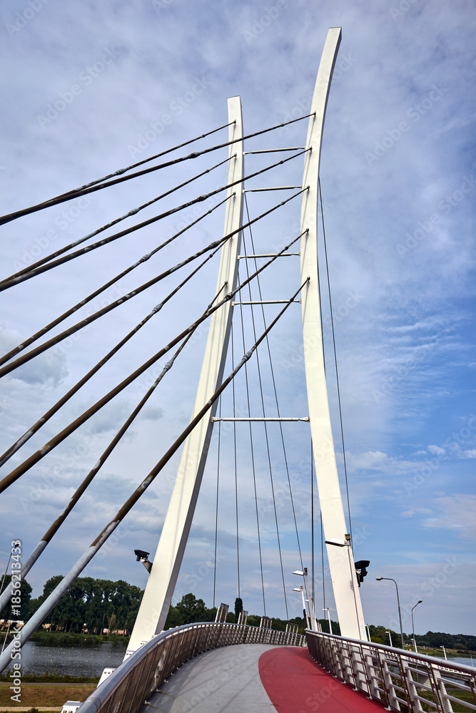Fototapeta premium Cable-stayed pedestrian bridge structure over Lake Malta in Poznan