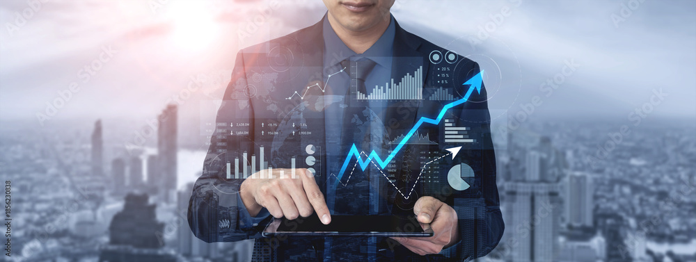 Obraz premium A businessman engaged in data analysis on a tablet, showcasing financial graphs and charts against a vibrant urban backdrop, illustrating modern commerce and innovation. Scalp