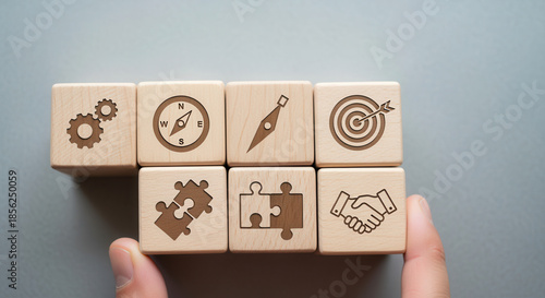 Wooden cubes showing productivity alignment icons positioned manually using realistic depth and gentle blurred background