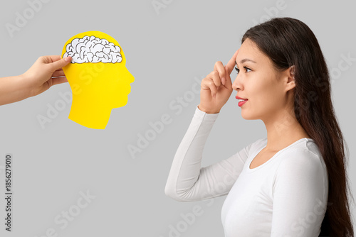 Young Asian woman pointing ...