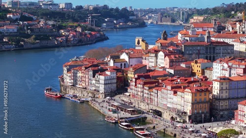 Ancient Porto city along the Douro River, colourful buildings, historic churches, and lively riverfronts, Drone shot