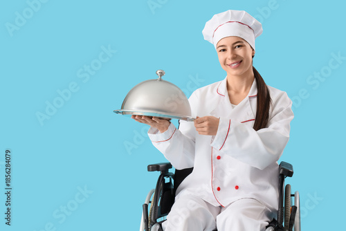 Young female chef with cloc...