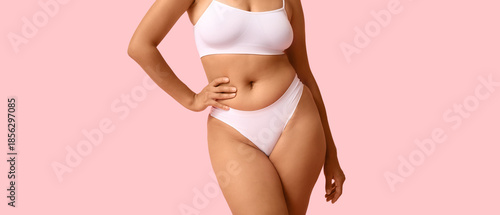 Beautiful young African-American body positive woman on pink background, closeup