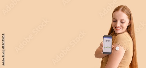 Cuadro en lienzo Woman with glucose sensor using mobile phone for measuring blood sugar level on