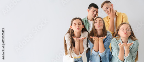 Group of happy friends blow...
