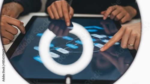 People collaborating on a digital interface, teamwork and technology concept.