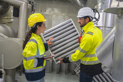 Engineering team evaluating airflow management in a modern industrial production zone.