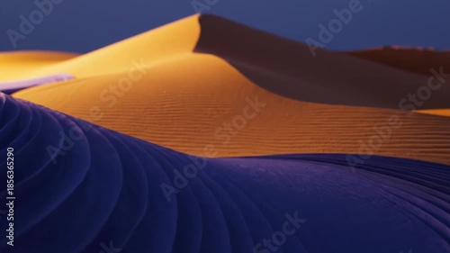 A serene desert landscape with majestic sand dunes at sunset or sunrise with warm orange and blue hues