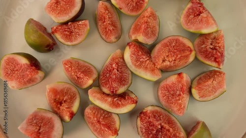 Figs slices on plate rotation top view. Selective focus.