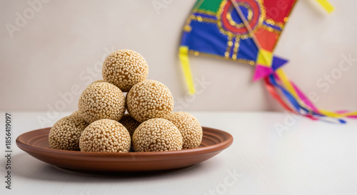 Traditional Indian Til Ladoo sweet with festive kite