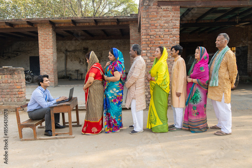 Rural indian people standing in a queue to get their documents verified to get benefits of government scheme.