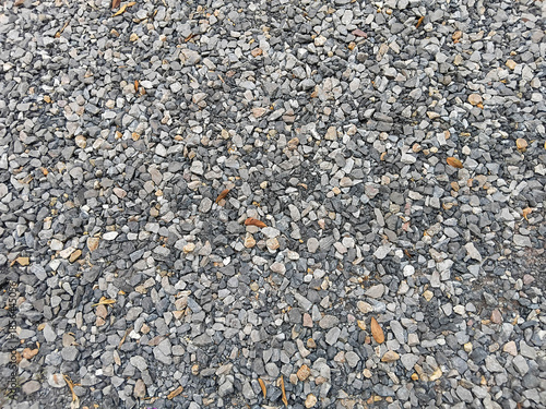 Natural gravel stone ground texture with small gray rocks, suitable for background, construction, outdoor design, and surface patterns.