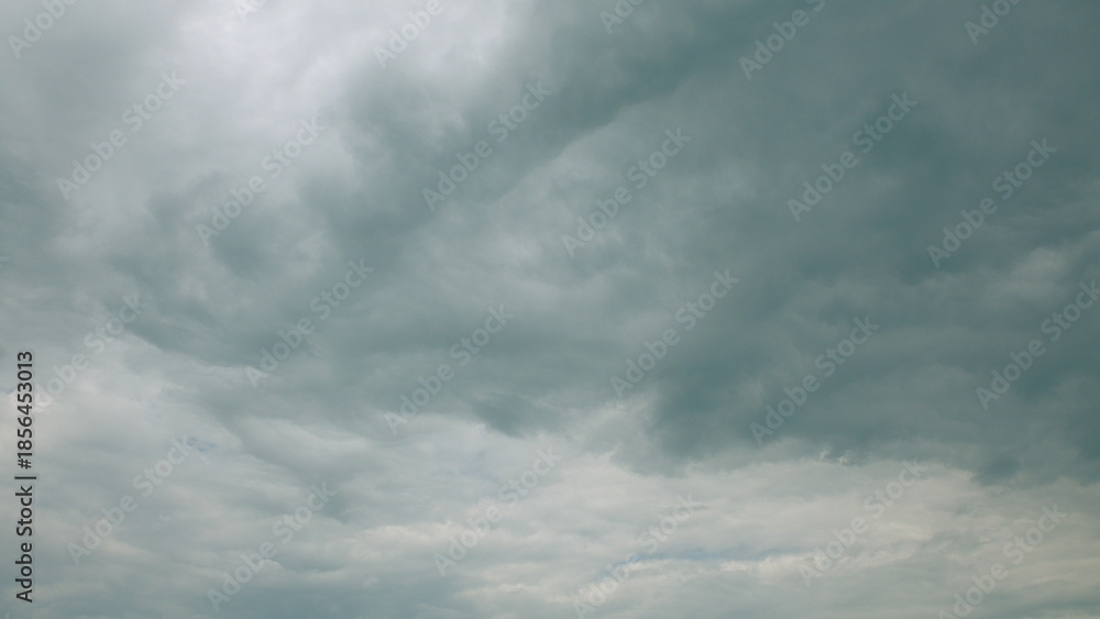 Fototapeta premium An Overcast Sky Filled with Dramatic and Intriguing Cloud Patterns Surrounding Us in Nature