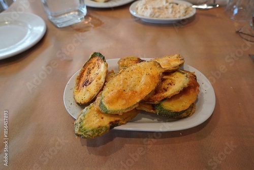 Fried zucchini slices served in a restaurant