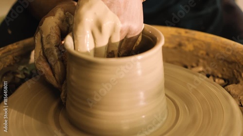 A pot is being given shape and structure