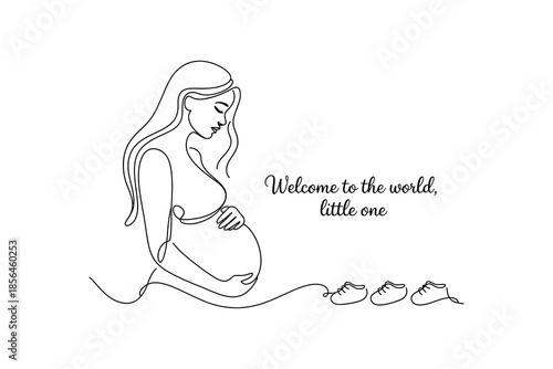 A pregnant woman sitting with her hands on her belly and baby shoes nearby