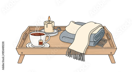 Cozy morning setup with steaming tea, candle, and blanket on wooden tray