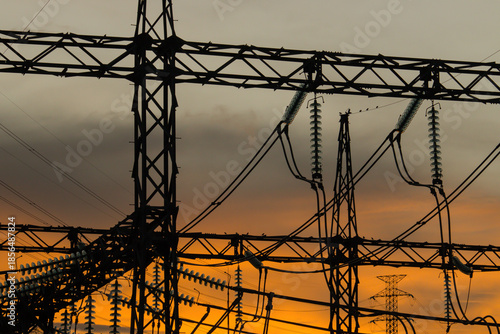 High Voltage Power Lines Silhouette at Sunset, Electricity Infrastructure Concept