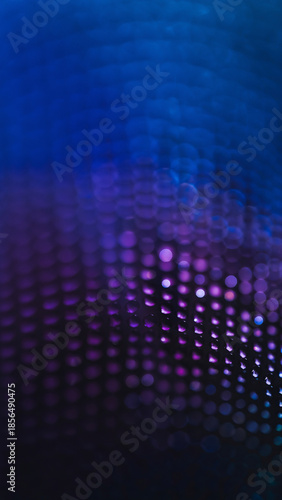 Vertical abstract background featuring deep blue and purple glowing bokeh lights with floating particles in a dark space.