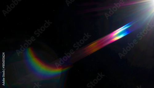 Bright lens flare with rainbow refraction against a dark, starry background