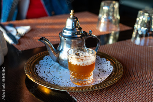 Traditional Moroccan mint tea served in metal teapot and glass