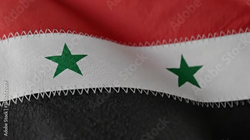 Syrian national flag waving smoothly in the wind. High-quality animated background representing independence, government, freedom, and Arab nation themes.