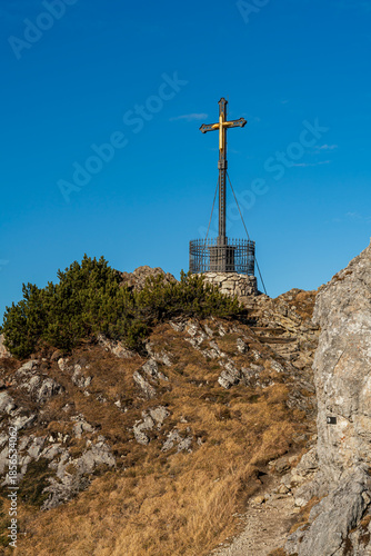The Bavarian summit cross at the peak of the mountain called Hochfelln which is located at the Chiemgau mountain range 