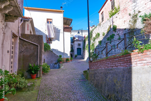 A narrow street among the old houses of Capriati a Volturno, a small town in the province of Caserta, Italy.