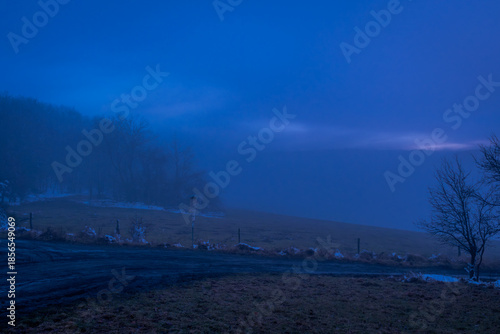 Winter blue hour after sunset with inversion fog near Cereniste village