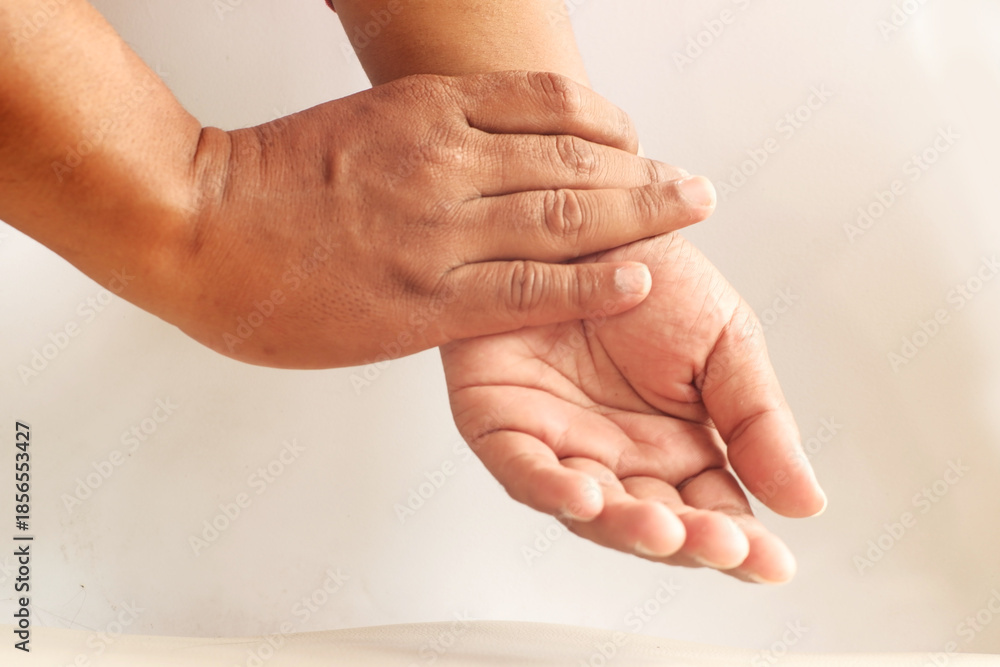 Fototapeta premium Close-Up of Hand Checking Pulse on Wrist