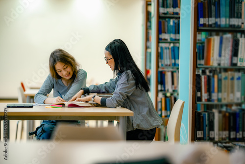 Photos School homework support scene with student reading textbook at library table guided learning atmosphere