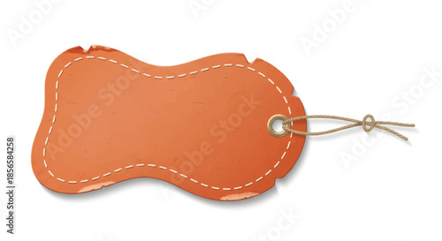 An orange, irregularly shaped blank tag with a stitched border and a tied twine string, casting a shadow.
