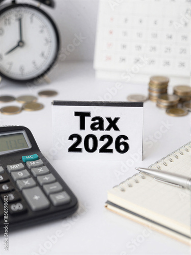 Tax planning 2026 with calculator notebook and coins