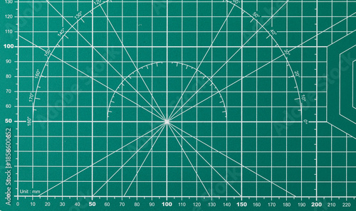 Green cutting mat with grid and measurement markings for precision work