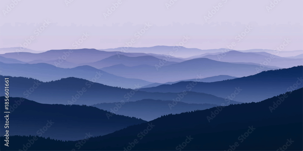 Fototapeta premium A misty blue mountain range at dawn with a forest valley under a soft morning sky where sunlight breaks through the fog and clouds over the peaks.