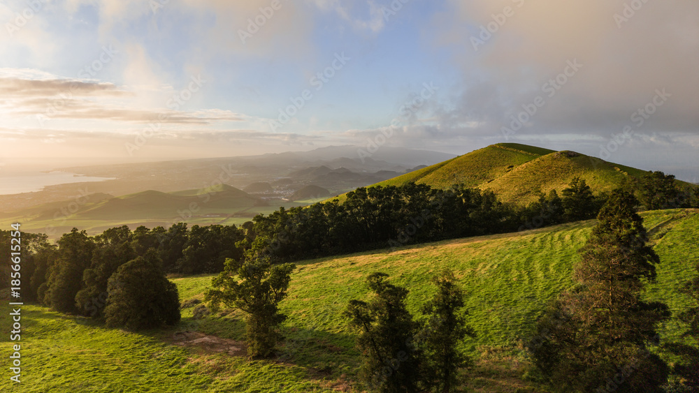 Obraz premium Sunset over green pastures, Azores islands, drone view.