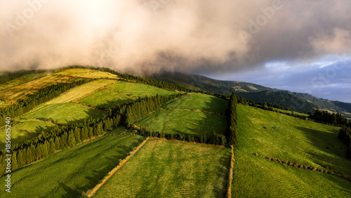 Sunset over green pastures, Azores islands, drone view.